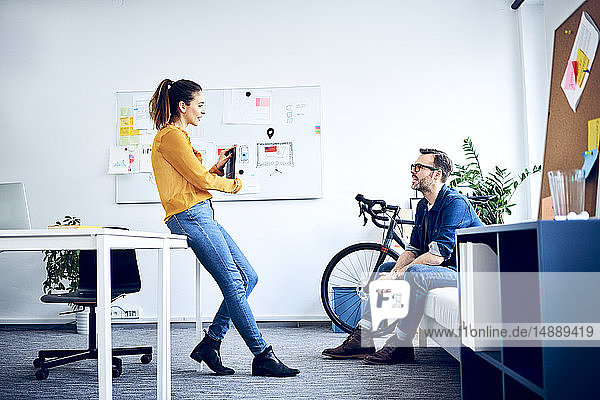 Two colleagues with tablet meeting in office