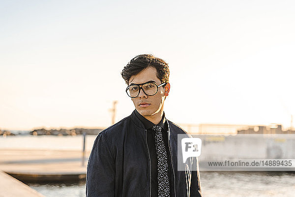 Portrait of fashionable young businessman wearing glasses and tie