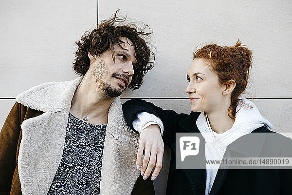 Portrait of confident couple at a wall