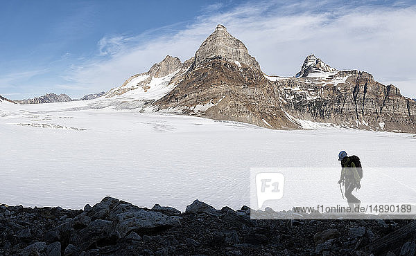 Greenland  Sermersooq  Kulusuk  Schweizerland Alps  mountaineer walking in snowy mountainscape