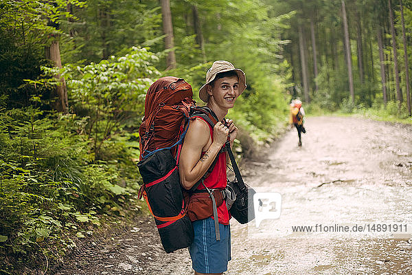 Young man hiking in forest at the Carpathian Mountain Range  Ukraine