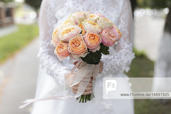 Hands of bride holding bouquet
