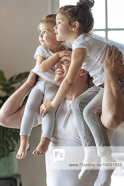 Father with his daughters on his shoulders