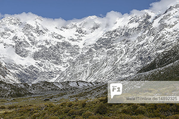 Cloud over snowcapped mountains in Mount Cook National Park New Zealand