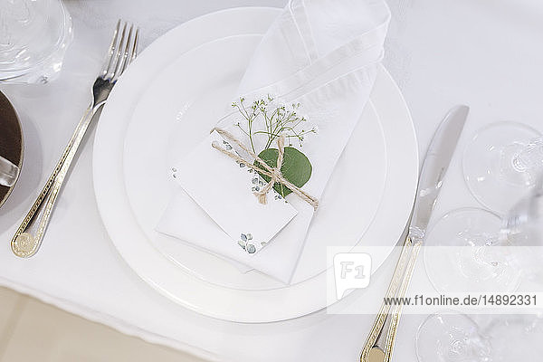 Wedding place setting with napkin on plate