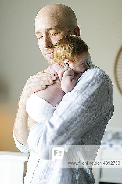 Man holding his newborn son