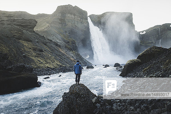 Hiker by Haifoss waterfall in Iceland