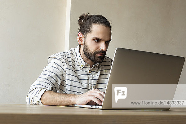 Young businessman using laptop