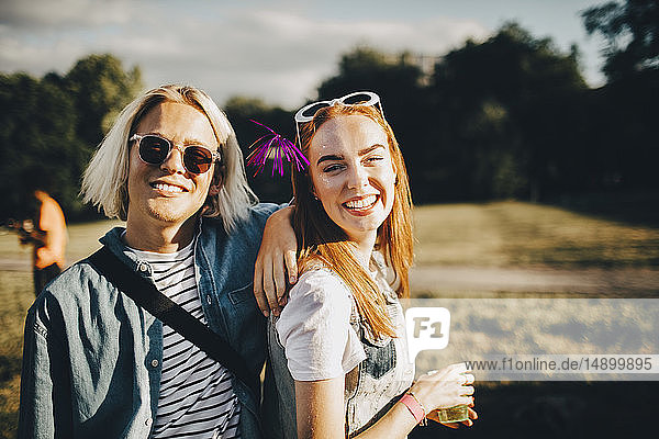 Portrait of smiling male and female friends at concert