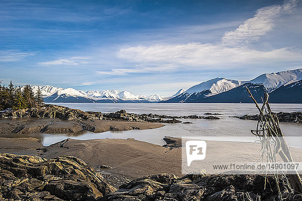 The in-coming tide on a calm winter day on the Turnagain Arm in South-central Alaska. The Chugach State Park and Chugach Mountains are in the background; Alaska United States fo America