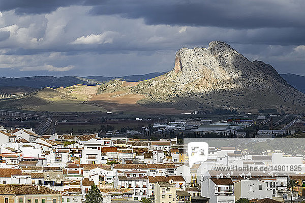 Rugged mountainous formation and houses in the cityscape of Antequera; Antequera Malaga Spain
