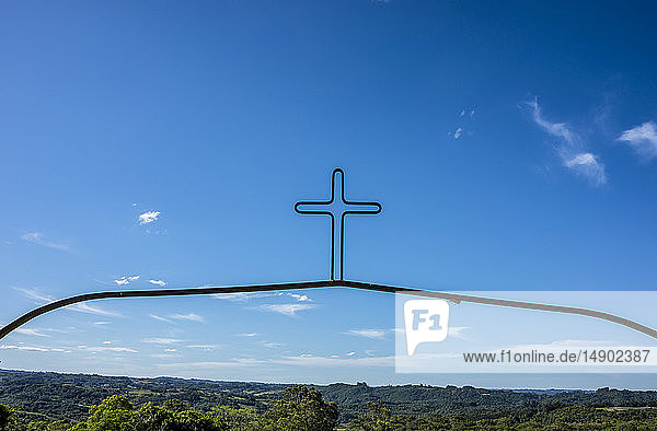 Decorative Metal Cross Against A Blue Sky With Green Landscape Pelotas Rio Grande Do Sul Brazil