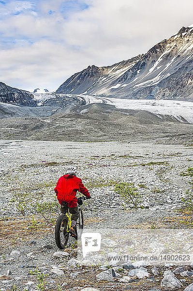 A man riding his fatbike in Gulkana Glacier Valley; Alaska  United States of America