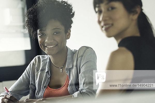 Smiling businesswomen sitting in office