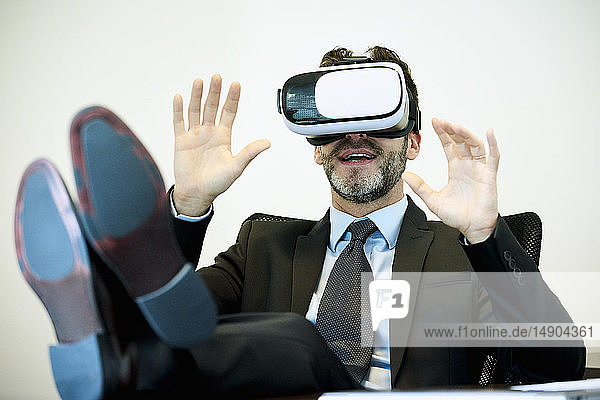 Businessman using virtual reality headset in office