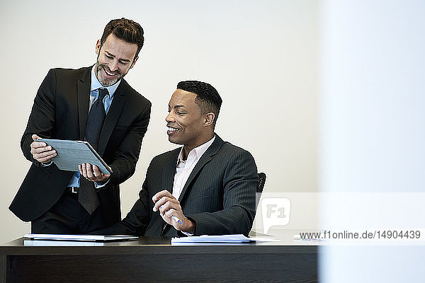 Businessmen using a digital tablet in office