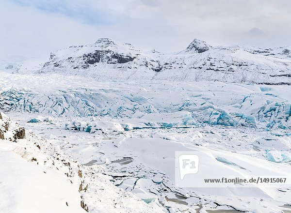 Glacier Svinafellsjoekull in Vatnajoekull NP in winter in Iceland. Glacier front and frozen glacial lake. Europe Northern Europe Scandinavia Iceland February.