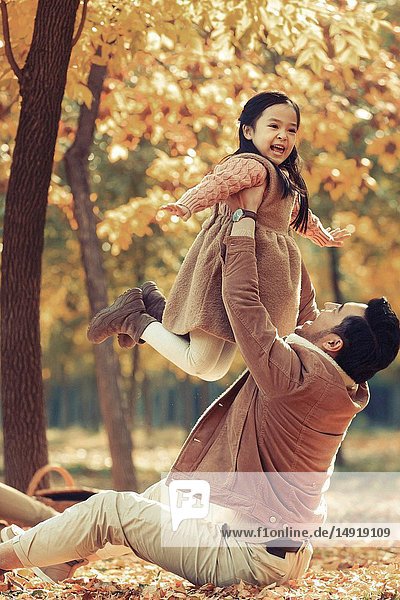 Father and daughter play outdoors