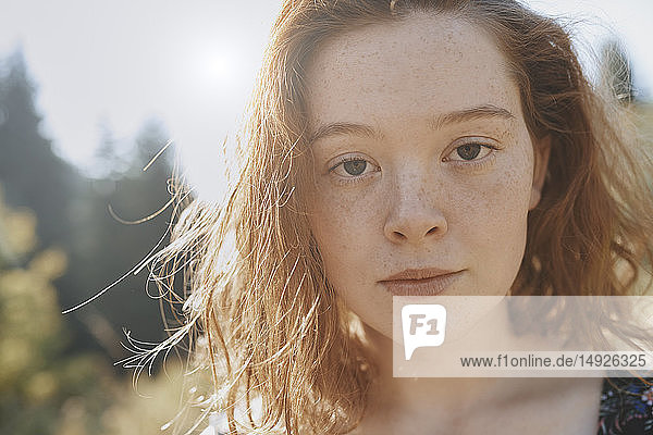 Close up portrait serious young woman with freckles