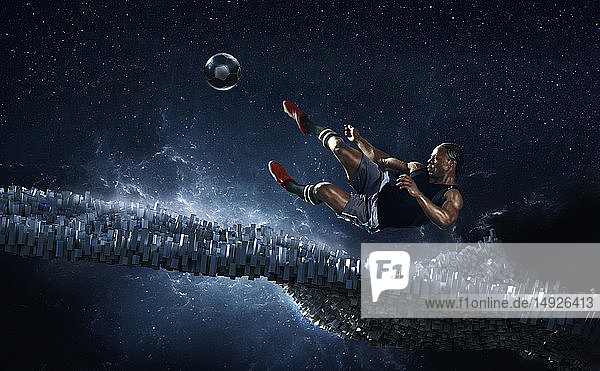 Male soccer player kicking soccer ball against futuristic background