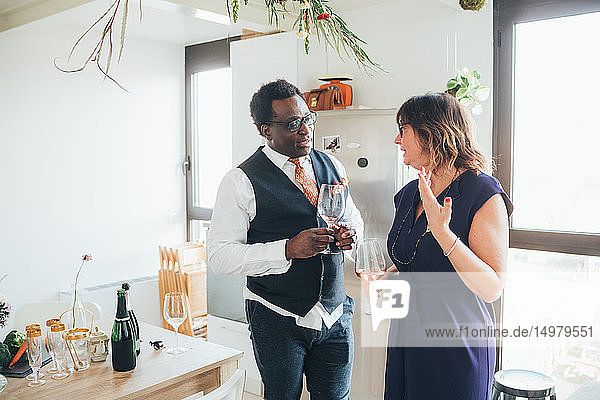 Businessman and businesswoman talking at party