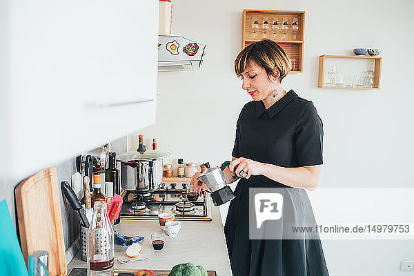 Businesswoman making coffee