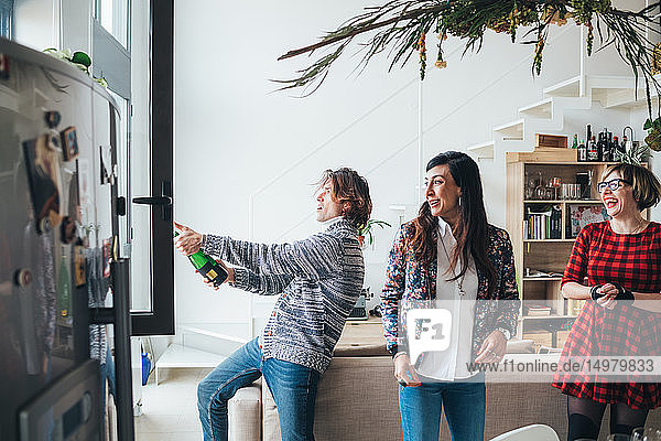 Friends celebrating with champagne in loft office