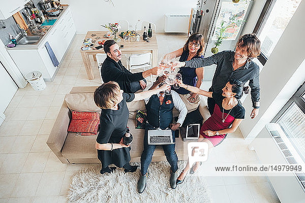 Businessmen and businesswomen toasting wine in loft office