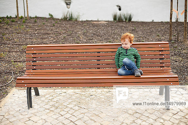 Portrait of boy on park bench