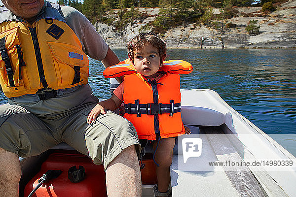 Grandfather and grandson on boat ride