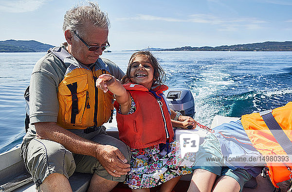 Grandfather and grandchildren on boat ride