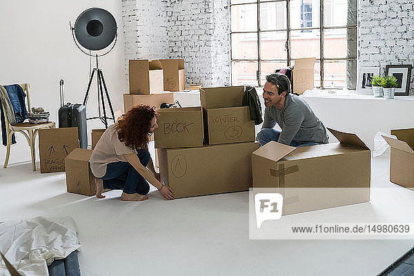Ehepaar zieht in eine Wohnung im Industriestil stapelt Kartons
