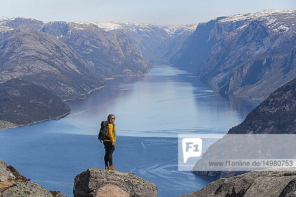 Wanderer  der die Aussicht auf die Klippen genießt  Preikestolen (Kanzelfelsen)  Lysefjord  Norwegen  Stavanger