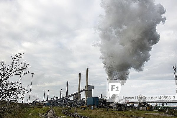 IJmuiden Netherlands. Huge heavy steel production plant and industry terrain producing various kinds of steel inside an CO2 emitting factory. The steel plant is called Hoogovens and is owned by Tata Steel an international corporation who also suffers from decline in revenues and ever increasing demands on corporate responsibility regarding labour and climate.