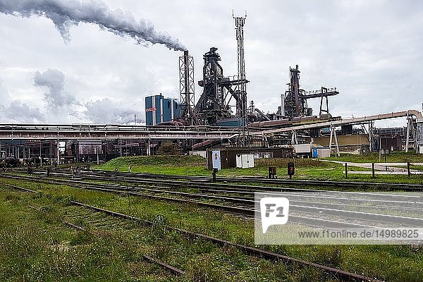 IJmuiden Netherlands. Huge heavy steel production plant and industry terrain producing various kinds of steel inside an CO2 emitting factory. The steel plant is called Hoogovens and is owned by Tata Steel an international corporation who also suffers from decline in revenues and ever increasing demands on corporate responsibility regarding labour and climate.