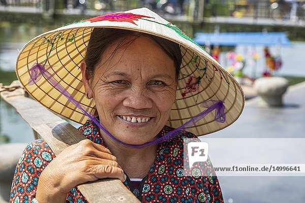 Portrait of an elderly Vietnamese woman wearing a traditional sampan hat also known as a 'rice hat'. Hoi An  Quang Nam provence  Vietnam  Asia.