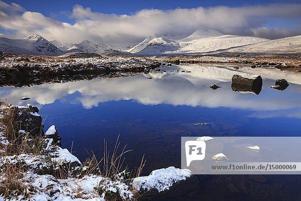 Snow covered Black Mount maintains reflected in the River Ba' on the southern edge of Rannoch Moor in the Scottish Highlands.