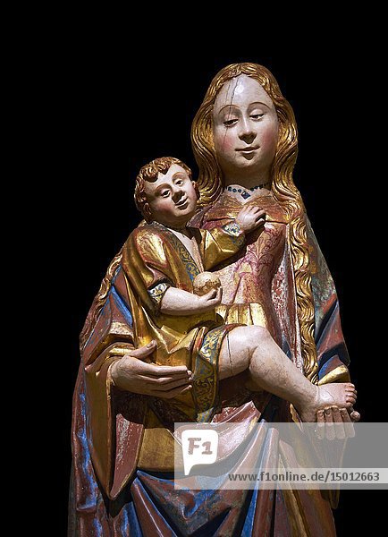 Gothic statue of The Virgin Mary (Madonna) holding the baby Jesus. Polychrome and gold leaf on wood by the Circle of Gil de Siloe around 1500  probably from Castella. Inv MNAC 64028. National Museum of Catalan Art (MNAC)  Barcelona  Spain. Against a black background.