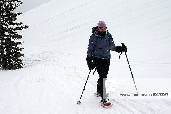 A woman  72  snowshoes near Hilda Peak  Banff National Park  Alberta  Canada.