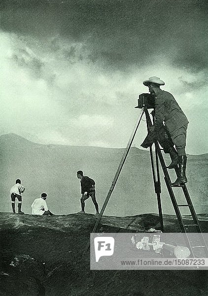 'Photographing at the Crater's Lip  Aso-San'  1910. Creator: Unknown.