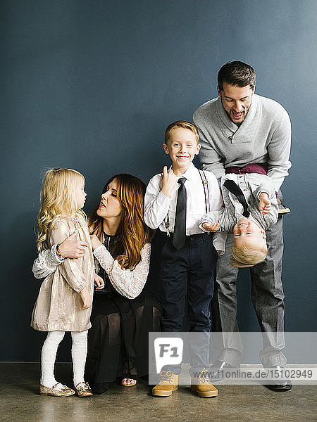 Gut gekleidete Familie mit drei Kindern