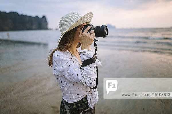 Young woman photographing on beach in Krabi  Thailand