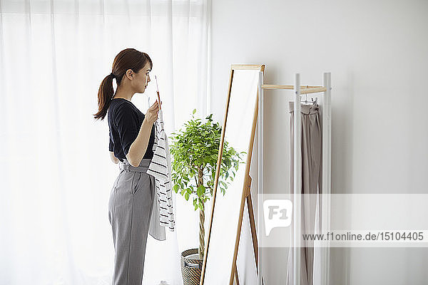 Young Japanese woman at home getting ready in the morning