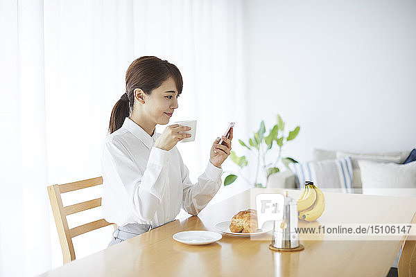 Junge Japanerin beim Frühstück zu Hause