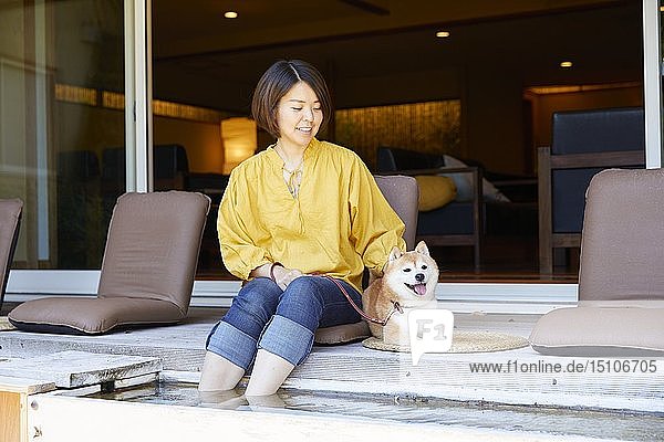 Japanese woman and Shiba Inu dog at traditional hotel