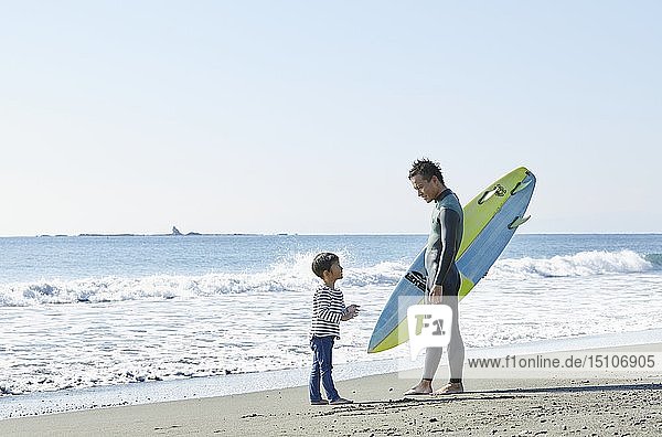 Japanese kid with father at the beach