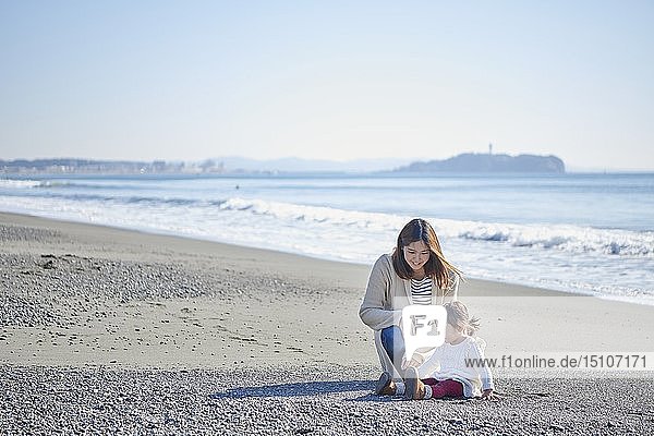 Japanese kid with mother at the beach