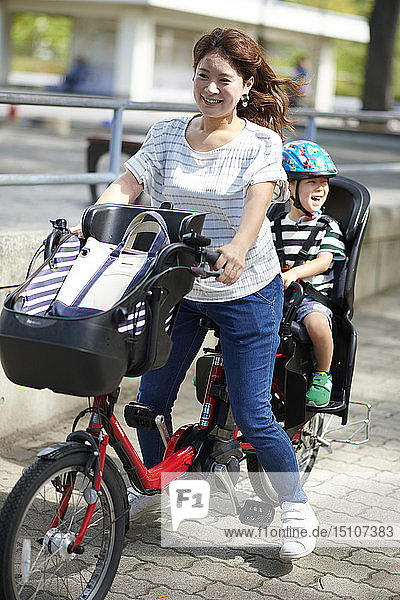 Japanese mother and kid riding a bike