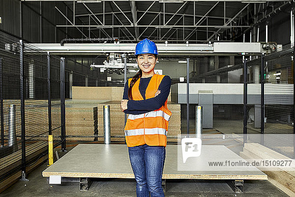 Portrait of smiling female worker in factory warehouse