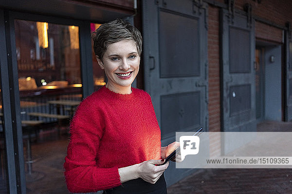 Germany  Berlin  portrait of confident businesswoman with digital tablet outdoors